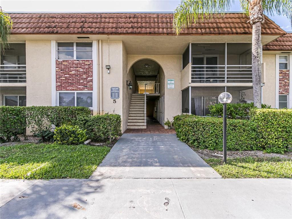22735 Southwest 66th Avenue, Unit 202 Boca Raton, FL 33428 - Photo 29 of 30 a front view of a house with a garden