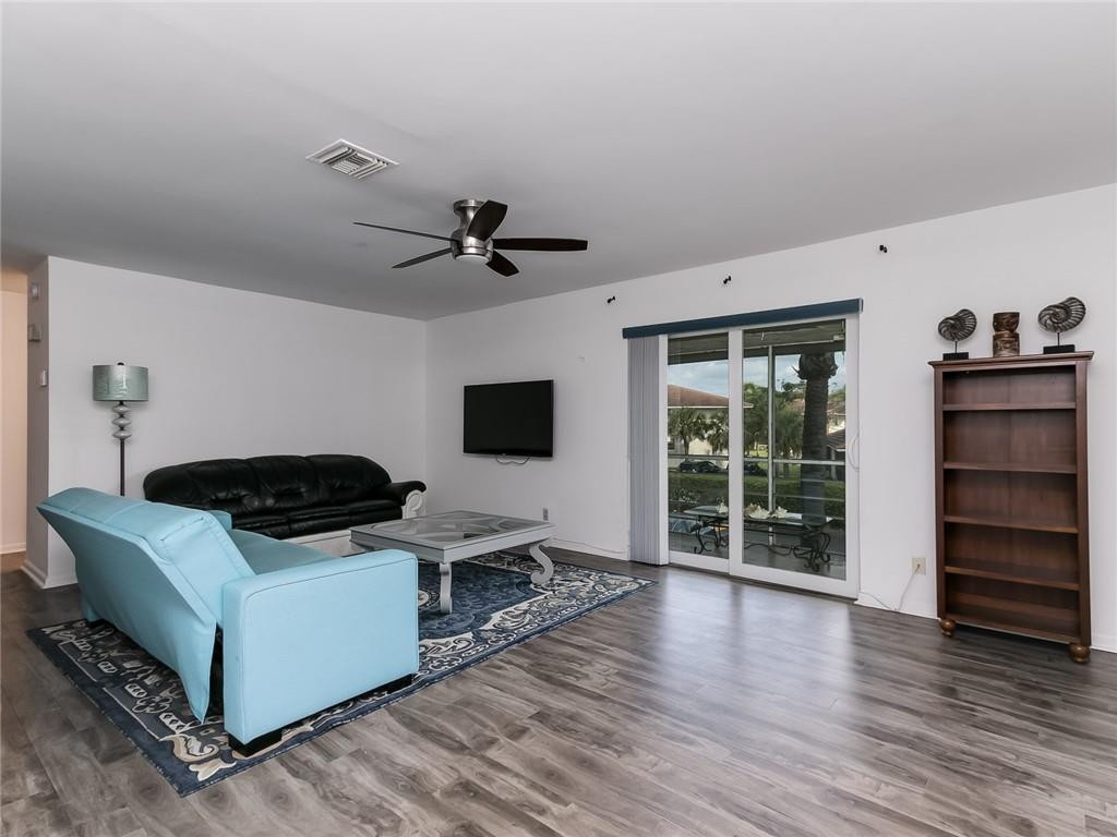 22735 Southwest 66th Avenue, Unit 202 Boca Raton, FL 33428 - Photo 8 of 30 a living room with furniture and a flat screen tv