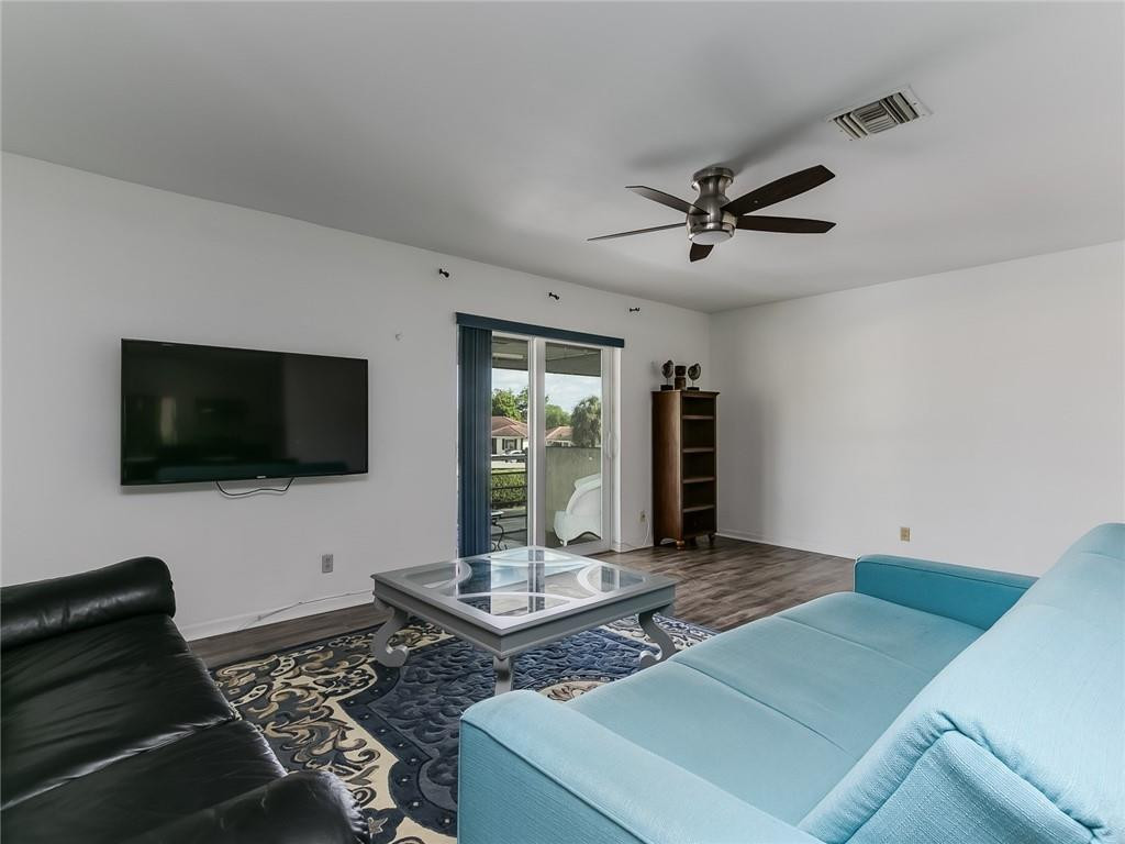 22735 Southwest 66th Avenue, Unit 202 Boca Raton, FL 33428 - Photo 9 of 30 a living room with furniture and a flat screen tv