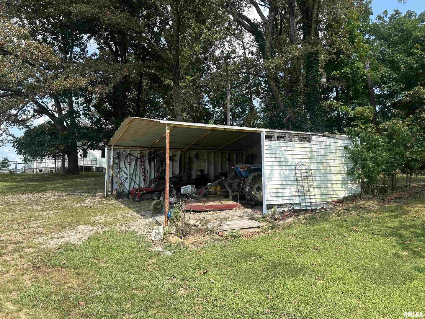 13536 Alleghany Road Thompsonville, IL 62890 - Photo 52 of 62 a view of a house with a yard patio and fire pit