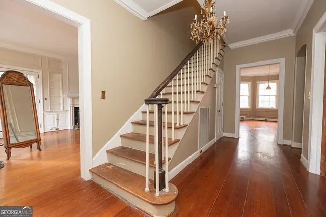 a view of entryway and hall with wooden floor