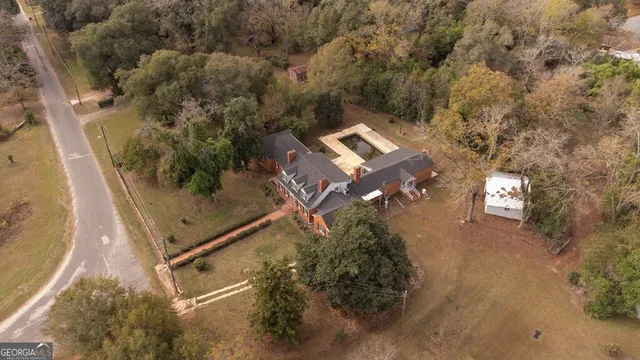 an aerial view of a house with a yard