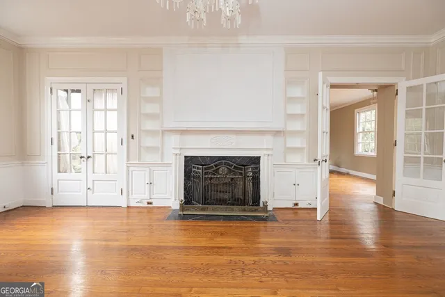 a view of a livingroom with wooden floor and a fireplace