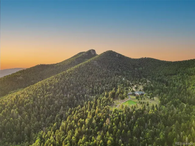 a view of a large mountain with mountains in the background