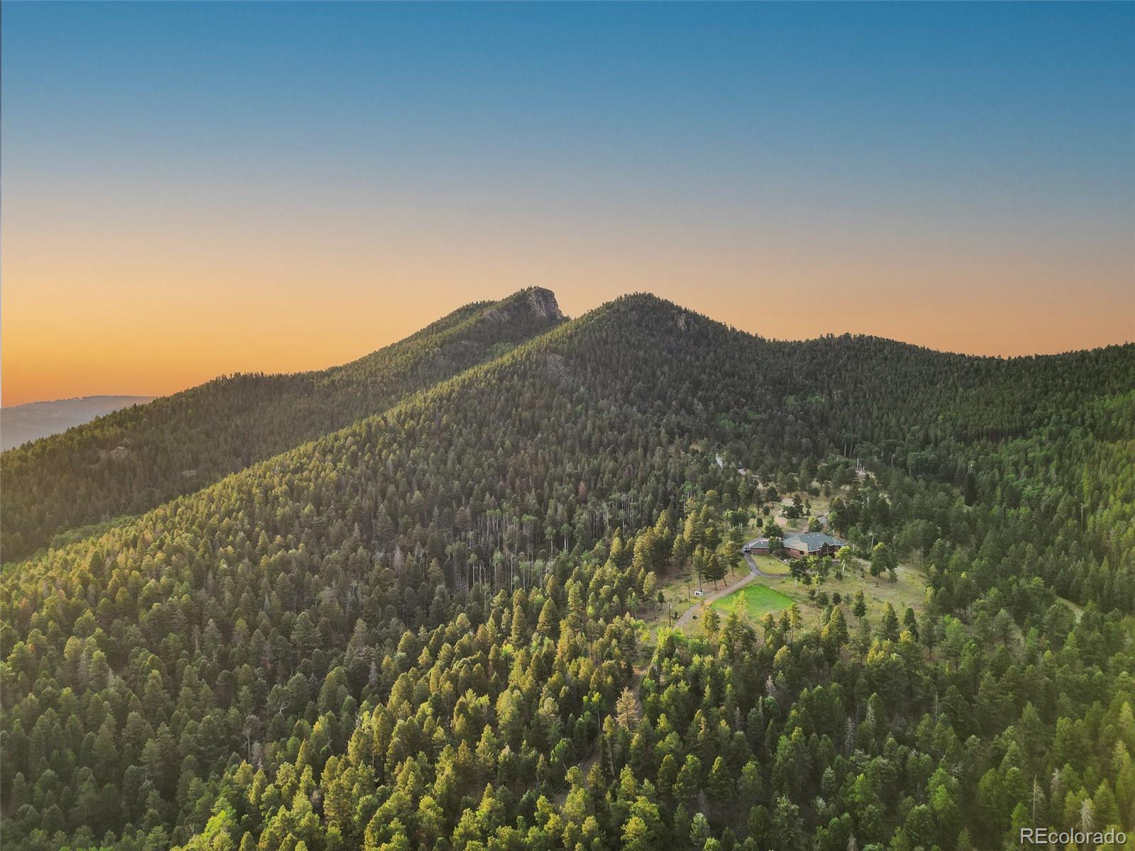 a view of a large mountain with mountains in the background