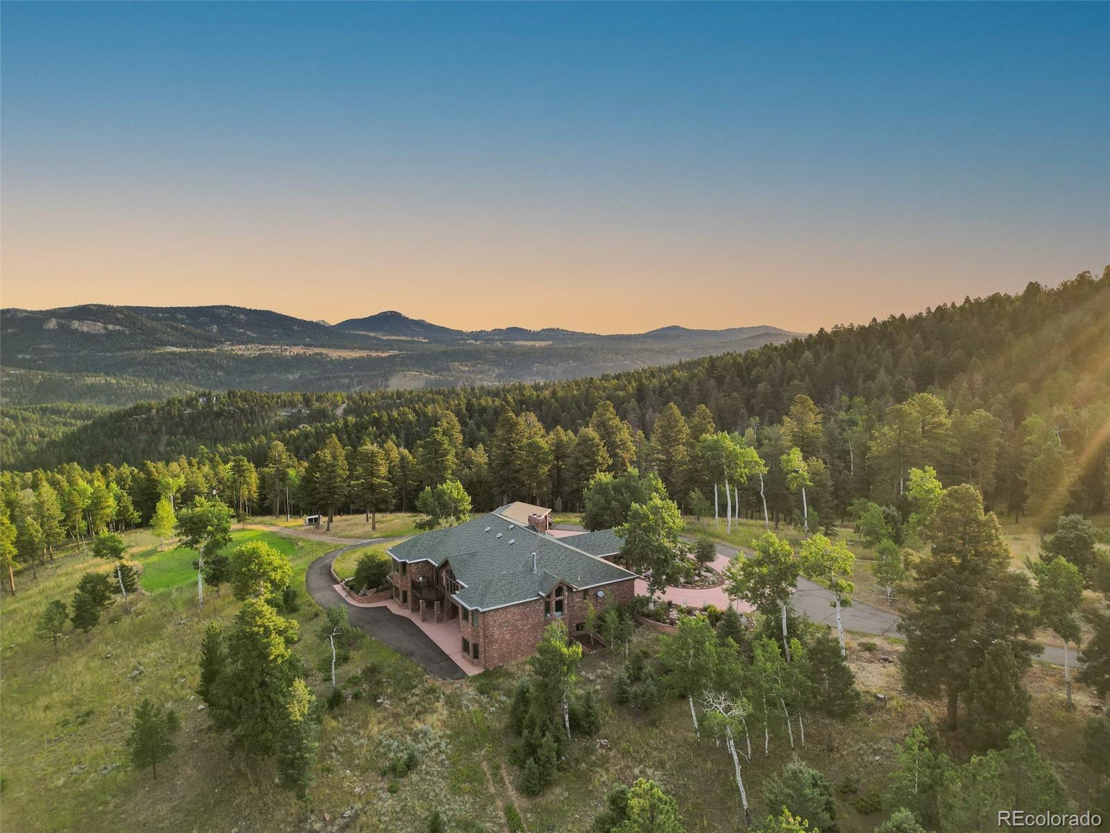 26271 Richmond Hill Road Conifer, CO 80433 - Photo 15 of 50 a view of a town with mountains in the background