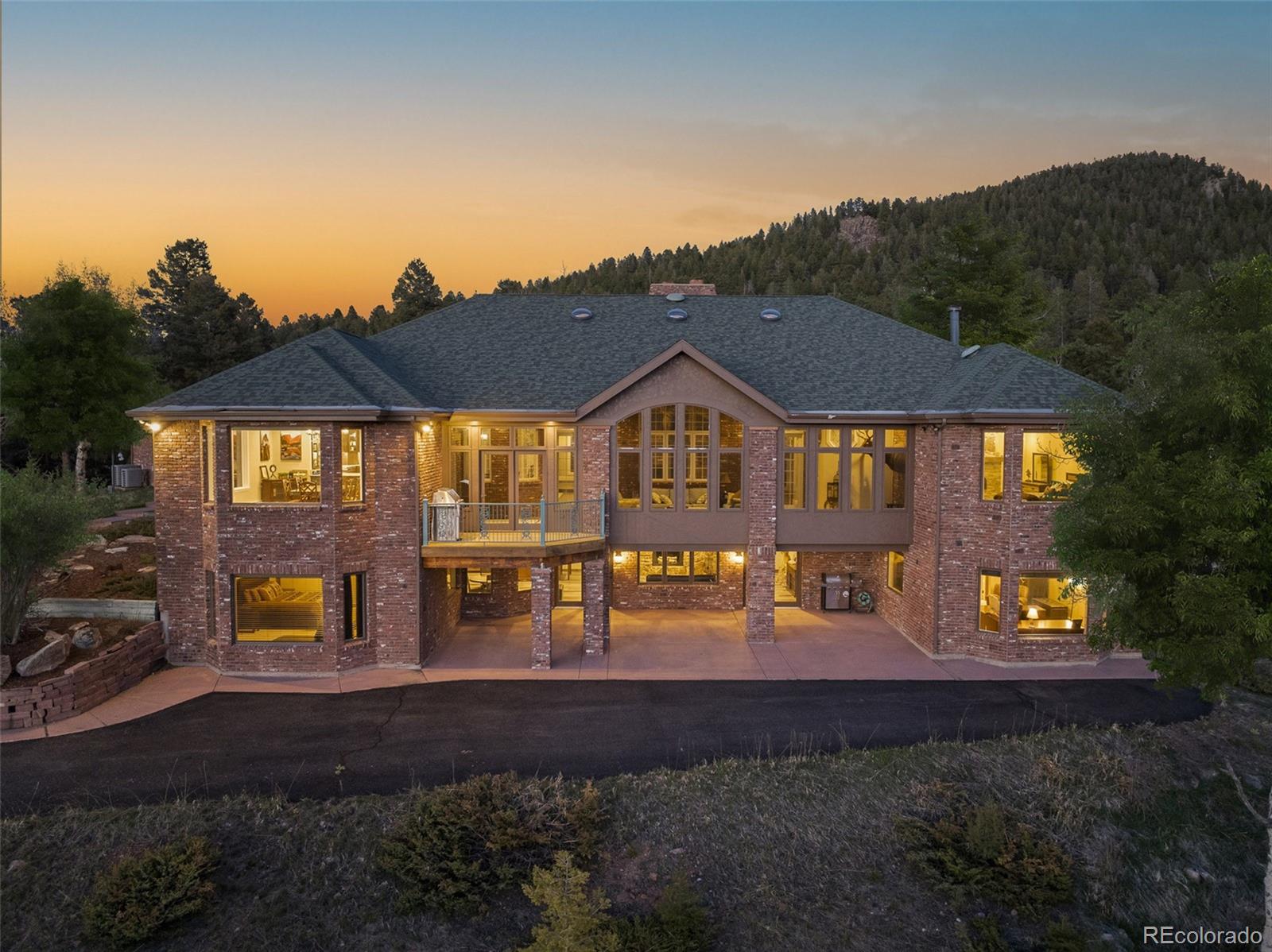 26271 Richmond Hill Road Conifer, CO 80433 - Photo 16 of 50 a front view of a house with garden