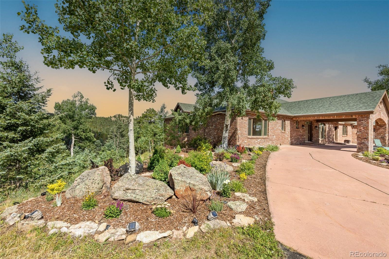 26271 Richmond Hill Road Conifer, CO 80433 - Photo 17 of 50 a view of a house with a chairs in a patio
