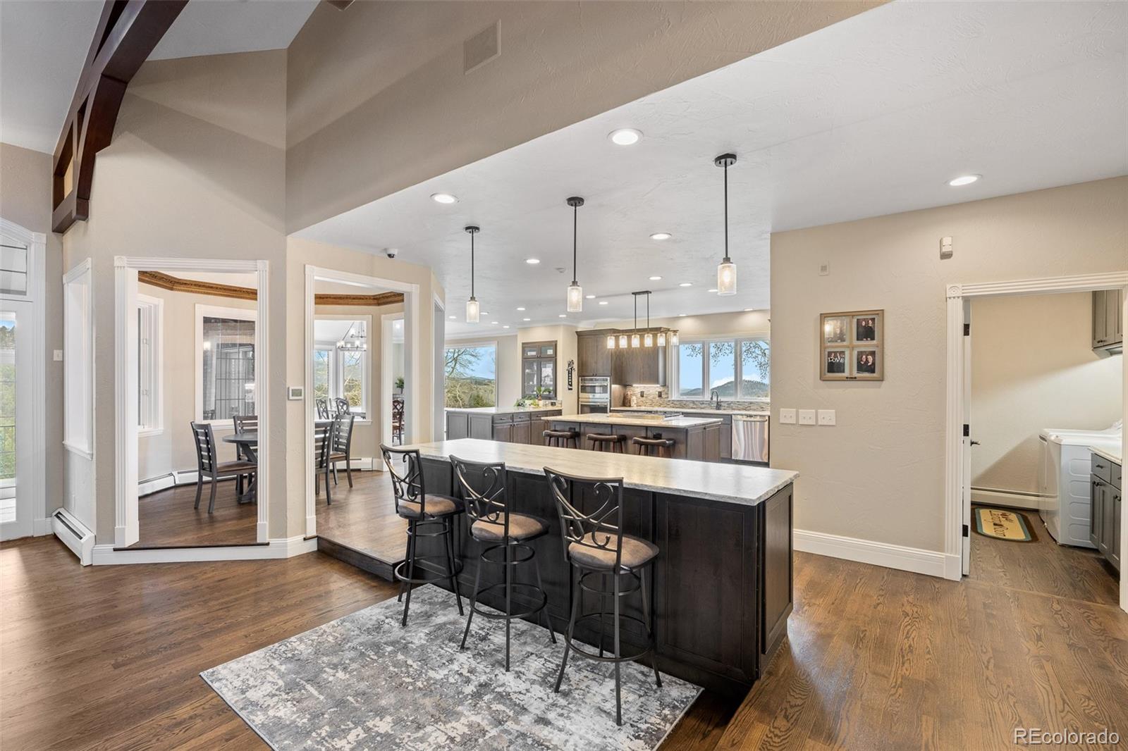 26271 Richmond Hill Road Conifer, CO 80433 - Photo 28 of 50 a dining hall with stainless steel appliances granite countertop a couch and wooden floor