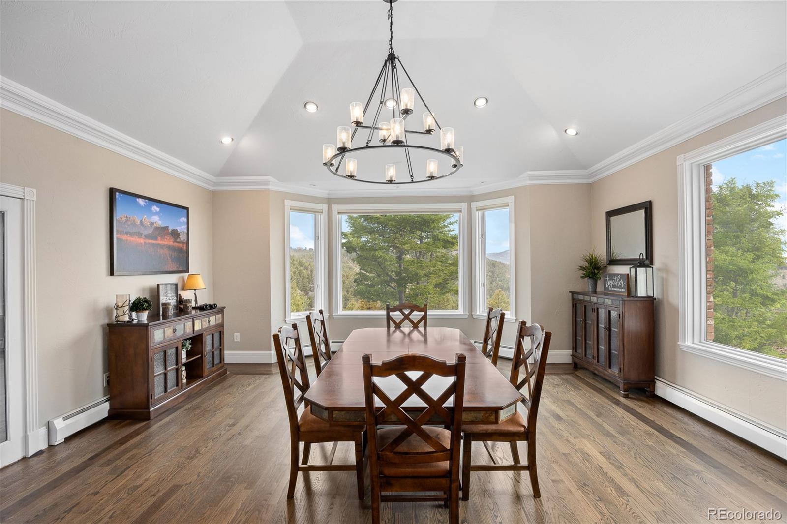 26271 Richmond Hill Road Conifer, CO 80433 - Photo 33 of 50 a view of a dining room with furniture window and wooden floor