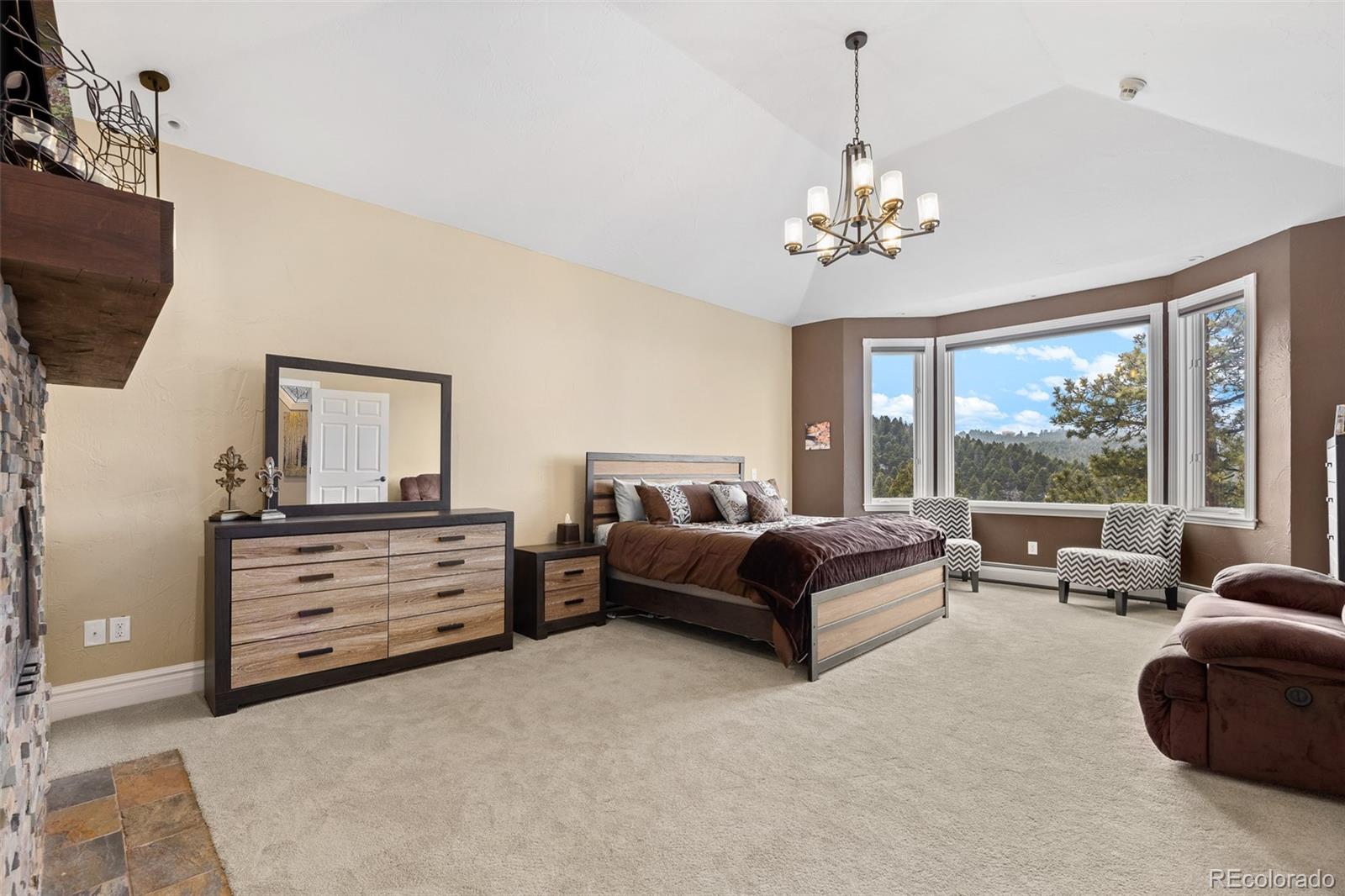26271 Richmond Hill Road Conifer, CO 80433 - Photo 34 of 50 a living room with furniture chandelier and a flat screen tv