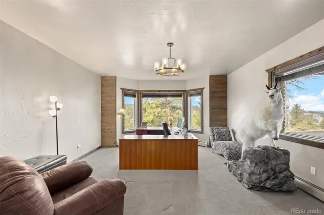 a bedroom with a bed a couch and large window