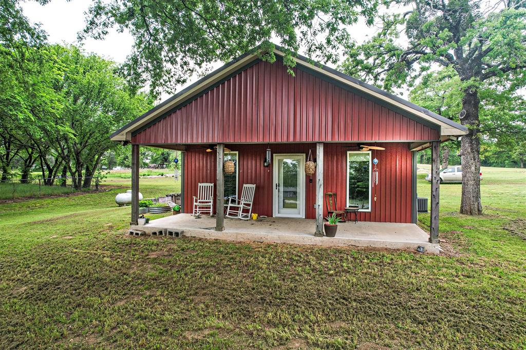 a view of a house with backyard porch and sitting area