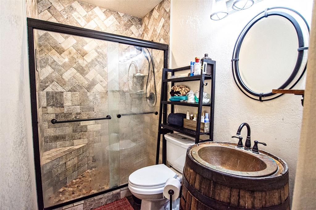 4850 Fm 1753 Denison, TX 75021 - Photo 11 of 23 a bathroom with a sink a toilet and a mirror