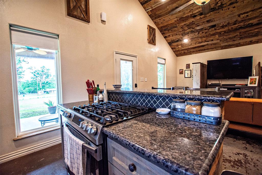 4850 Fm 1753 Denison, TX 75021 - Photo 5 of 23 a kitchen with stainless steel appliances granite countertop a stove a sink and a microwave