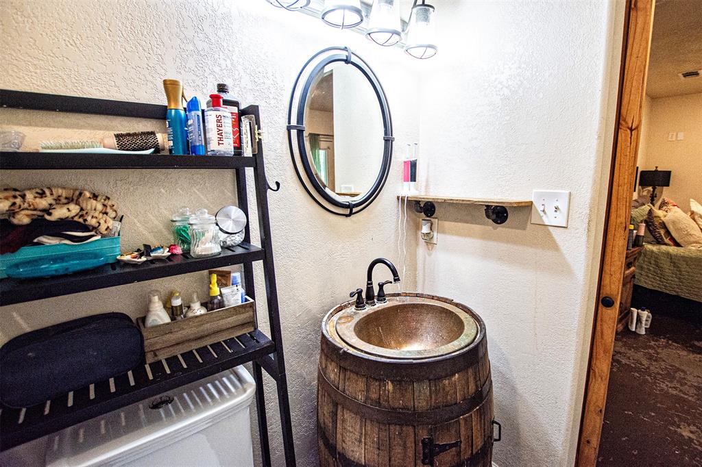 4850 Fm 1753 Denison, TX 75021 - Photo 10 of 23 a bathroom with a sink a toilet and a mirror