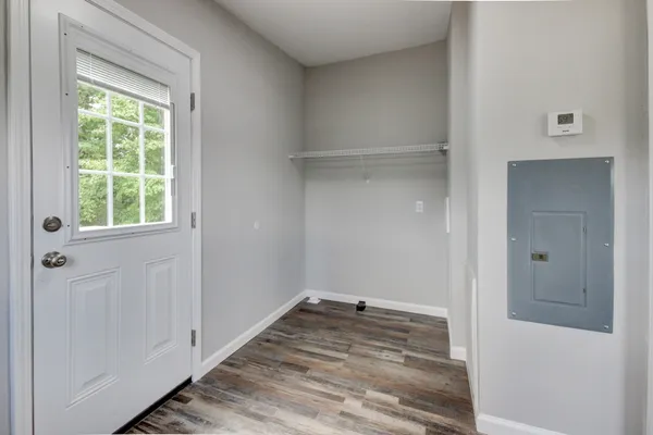 a view of an empty room with a fireplace and a window