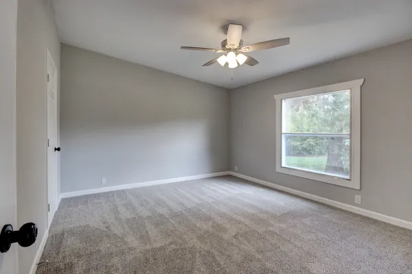 an empty room with a bathroom and a bathroom