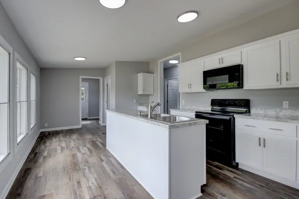 a kitchen with a sink and a stove top oven