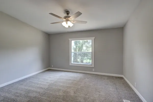 a bathroom with a sink and mirror with toilet