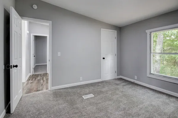 a view of an empty room and closet area