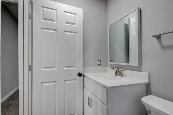 a view of a house with a backyard and trees