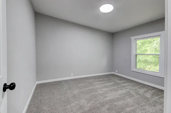 a view of a house with a yard and trees