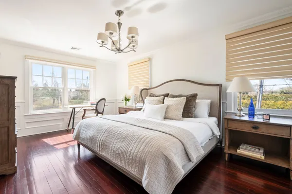 a bedroom with a bed and a chandelier