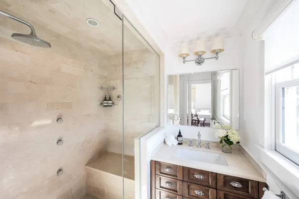 a bathroom with a sink vanity granite tub and shower