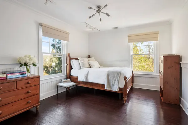 a bed sitting in a bedroom next to a window