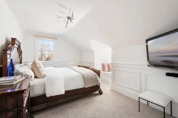 a bedroom with a bed and window