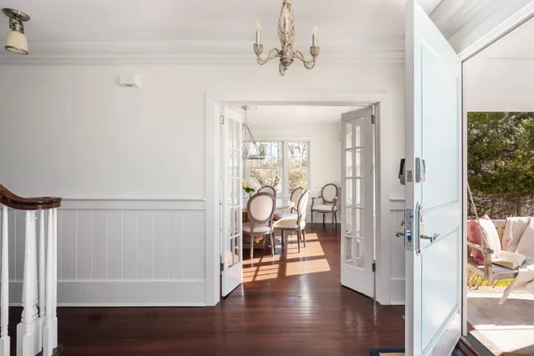a view of a hallway with wooden floor and staircase