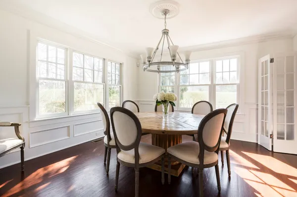 a view of a dining room with furniture window and wooden floor