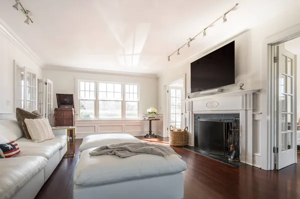 a spacious bedroom with a bed and a flat screen tv