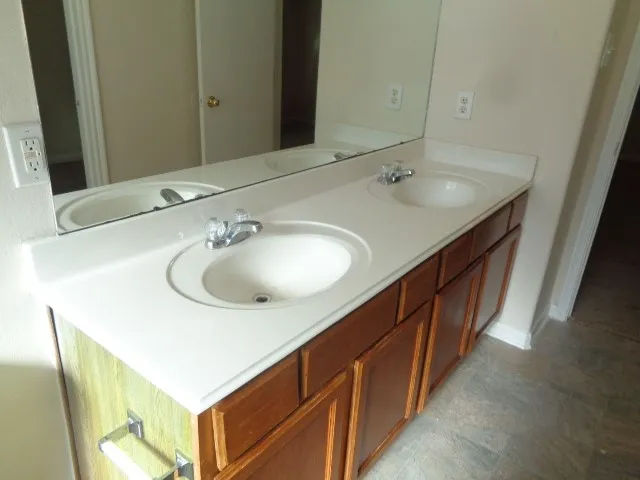 a bathroom with a sink and a large mirror
