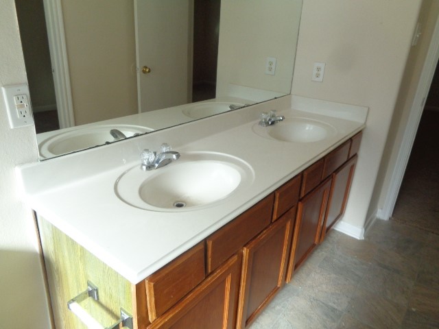 13018 Kingston Point Lane Houston, TX 77047 - Photo 13 of 28 a bathroom with a double vanity sink and a mirror