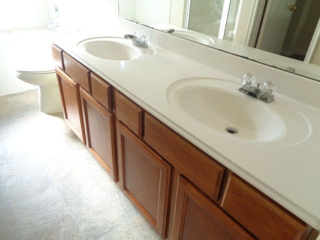 13018 Kingston Point Lane Houston, TX 77047 - Photo 14 of 28 a bathroom with a sink and a large mirror