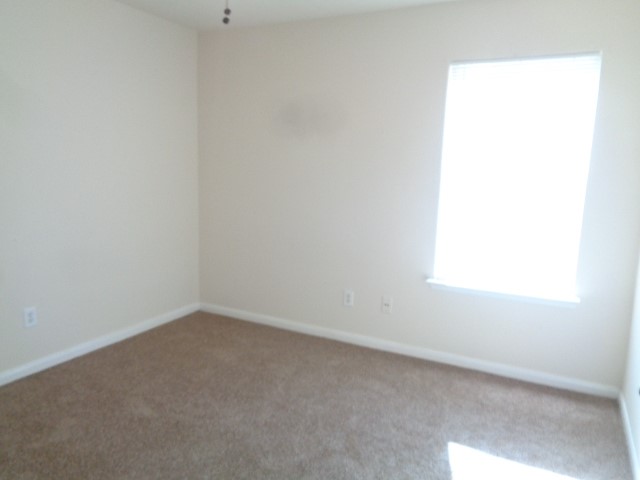 13018 Kingston Point Lane Houston, TX 77047 - Photo 18 of 28 an empty room with a window