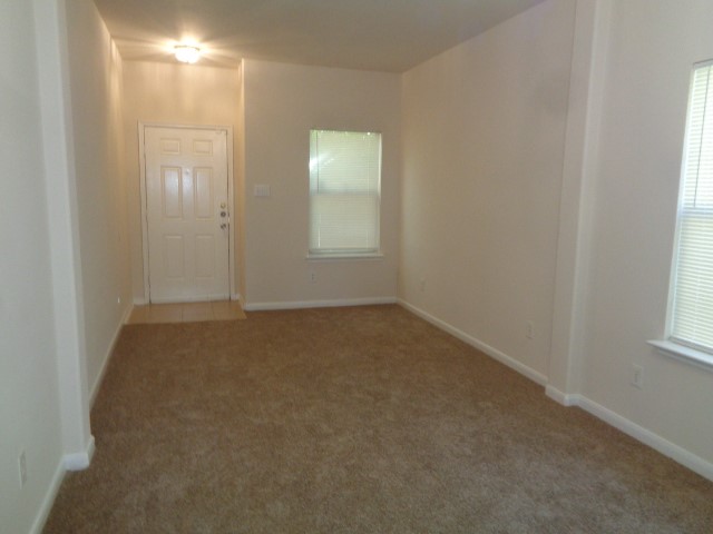 13018 Kingston Point Lane Houston, TX 77047 - Photo 6 of 28 an empty room with windows