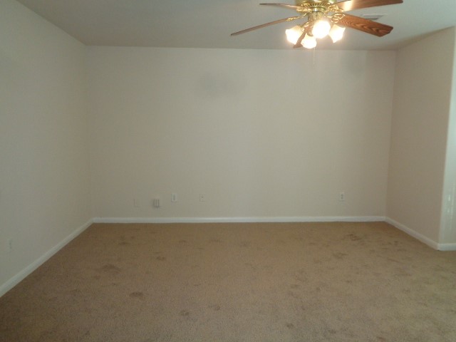 13018 Kingston Point Lane Houston, TX 77047 - Photo 10 of 28 an empty room with a chandelier fan