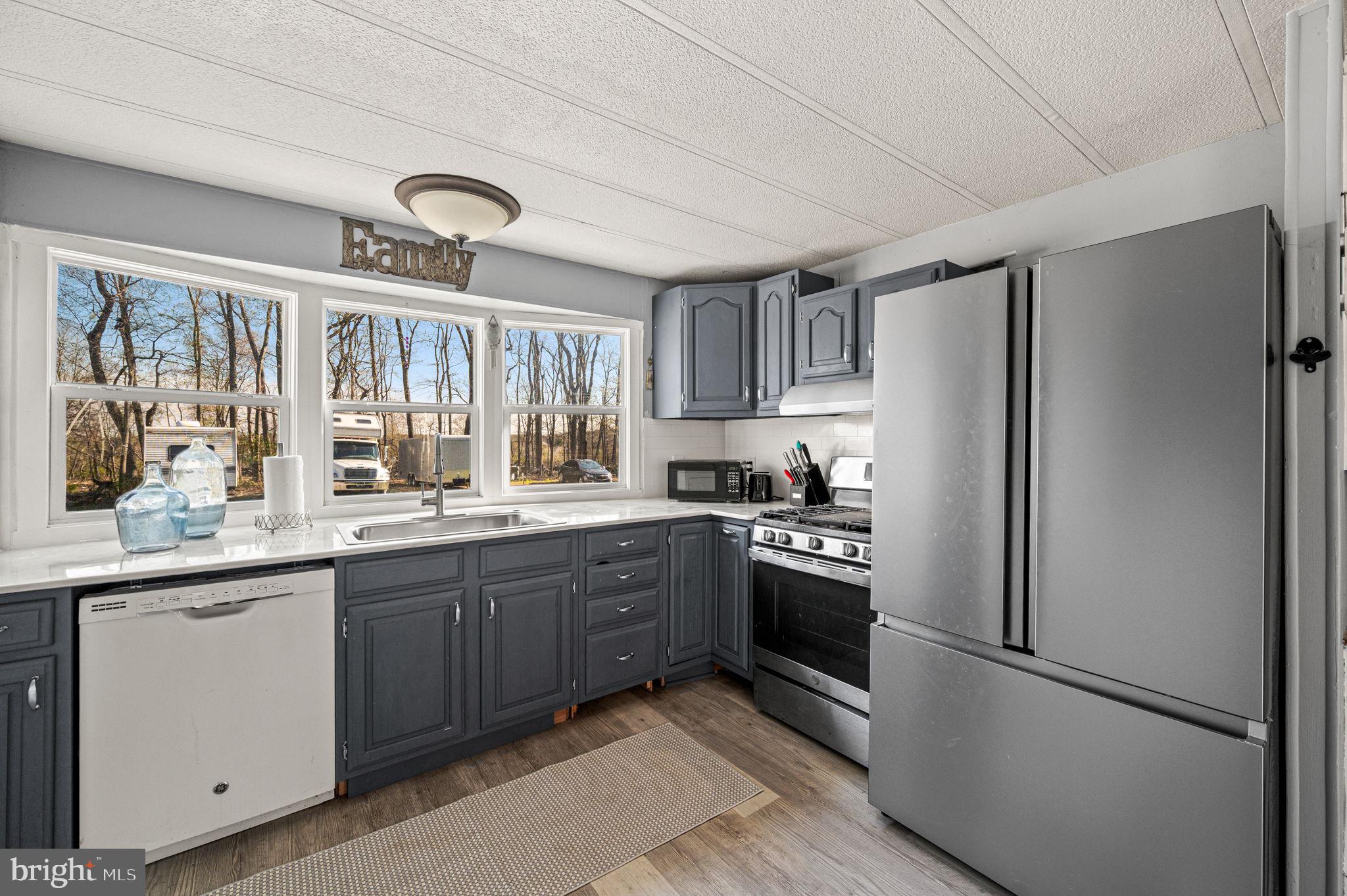 1725 Goosetown Road Coatesville, PA 19320 - Photo 16 of 34 a kitchen with stainless steel appliances granite countertop a refrigerator and a sink