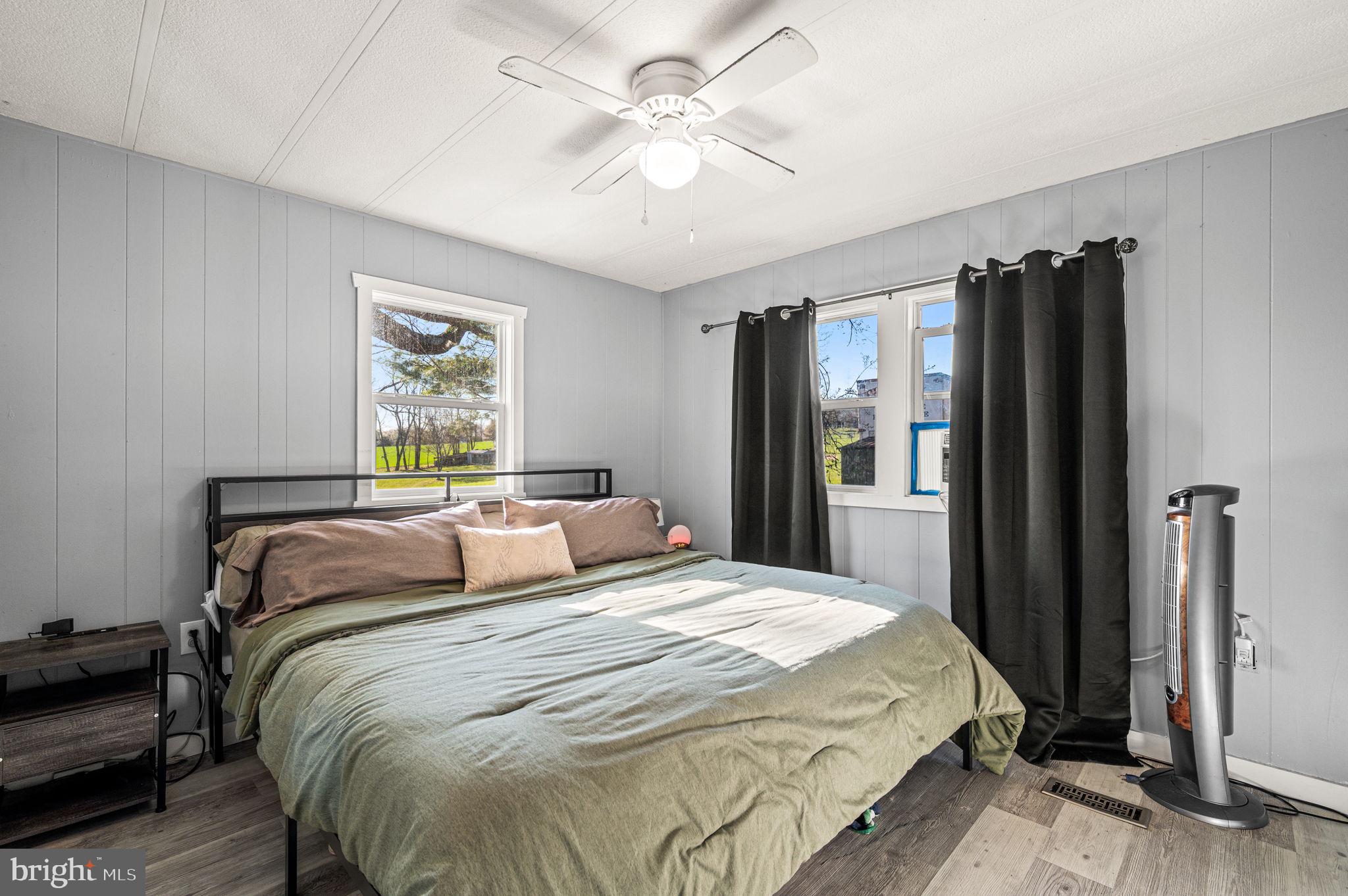 1725 Goosetown Road Coatesville, PA 19320 - Photo 23 of 34 a bedroom with a large bed and a chandelier
