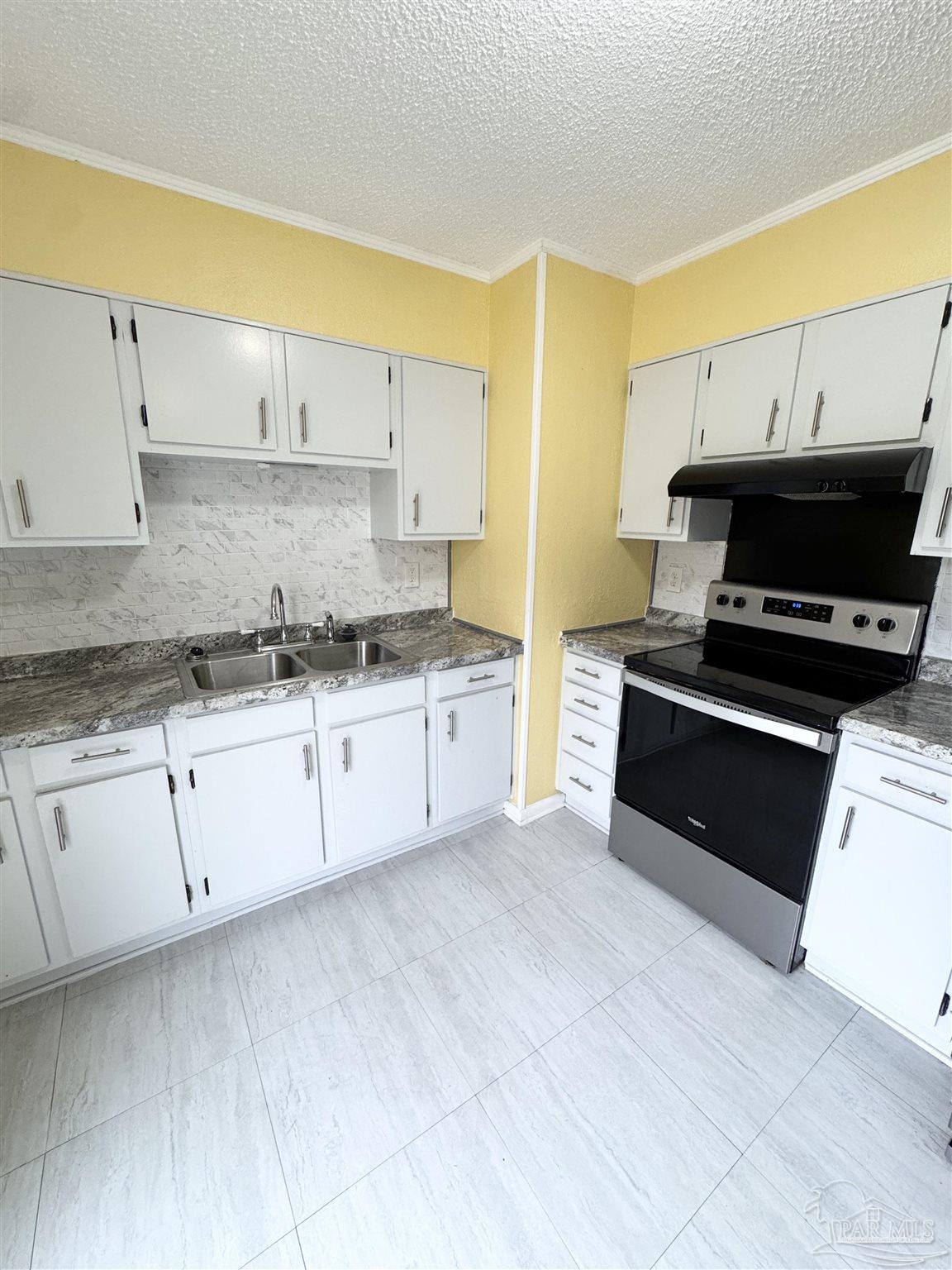 6320 Denver Avenue Pensacola, FL 32526 - Photo 14 of 28 a kitchen with granite countertop a stove a sink and a granite counter tops