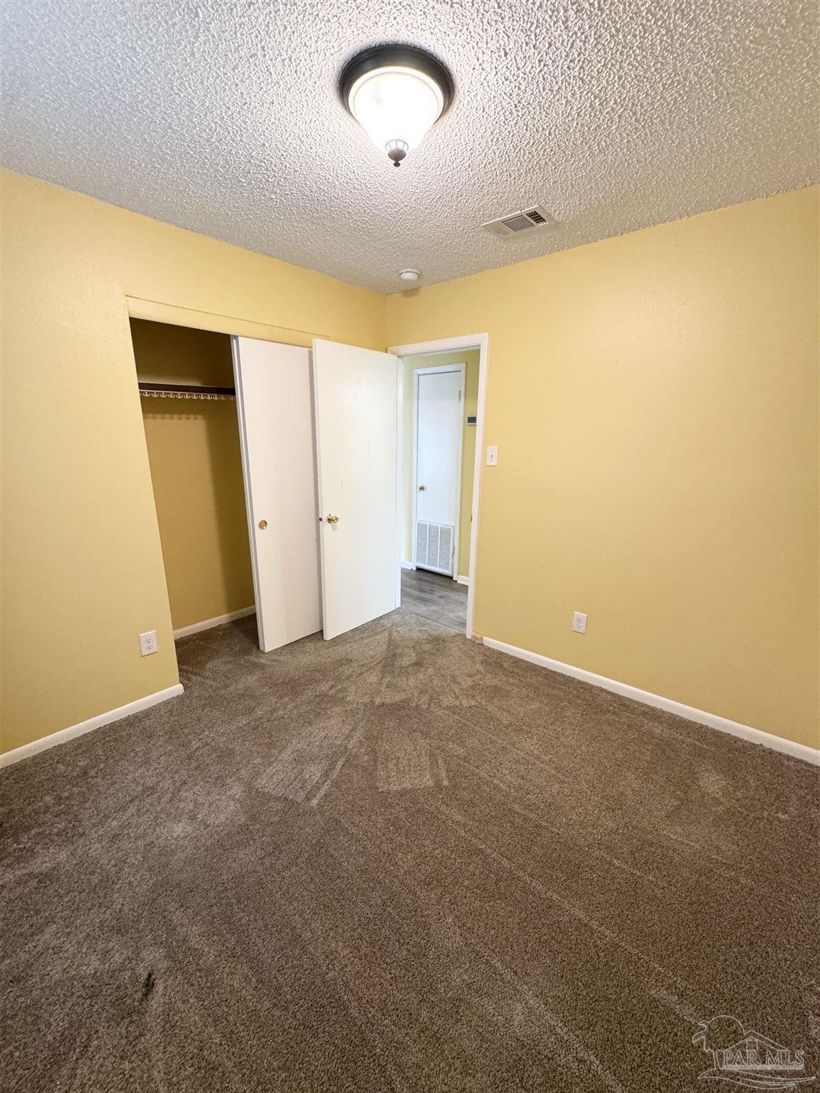 6320 Denver Avenue Pensacola, FL 32526 - Photo 17 of 28 an empty room with a natural light
