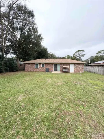 a view of a house with yard and sitting area