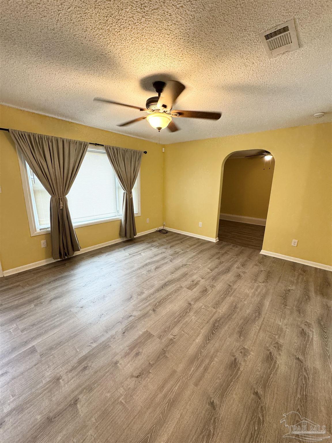 6320 Denver Avenue Pensacola, FL 32526 - Photo 5 of 28 a view of empty room with a ceiling fan
