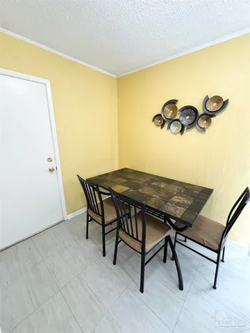 a view of a room with a table and chairs