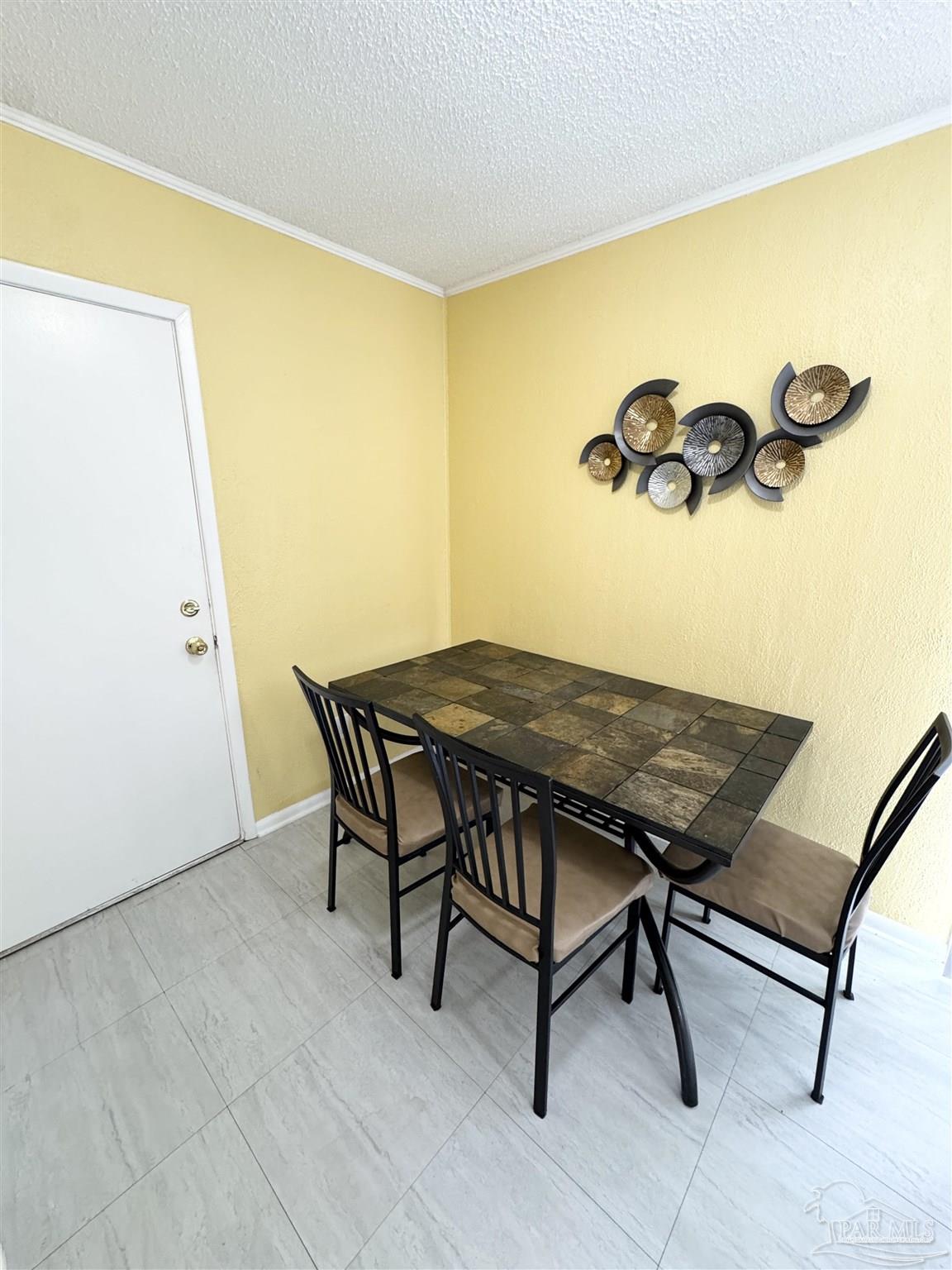 6320 Denver Avenue Pensacola, FL 32526 - Photo 10 of 28 a view of a room with a table and chairs