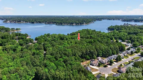 an aerial view of a house with a garden and lake view