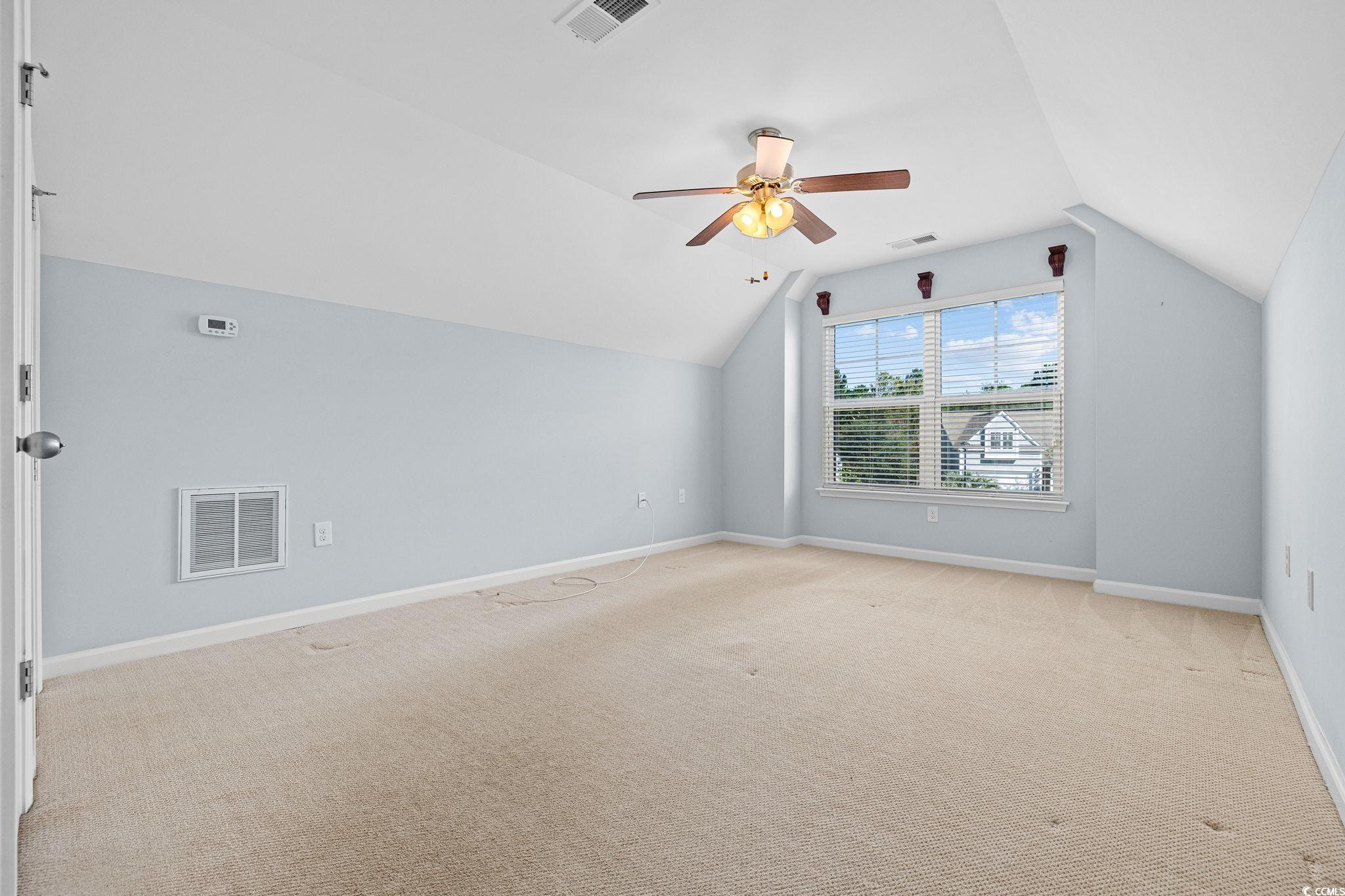 817 Arezzo Way, Unit 1001 Myrtle Beach, SC 29579 - Photo 30 of 40 Additional living space featuring light colored carpet, vaulted ceiling, and a ceiling fan